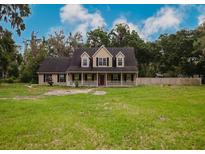 Charming two-story home with a welcoming front porch and a spacious front yard, perfect for outdoor activities at 6801 County Rd 665, Bushnell, FL 33513