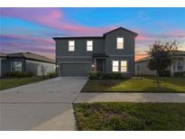 Charming two-story home with a well-maintained lawn and beautiful sunset sky at 1629 Hill Park Dr, Deltona, FL 32725