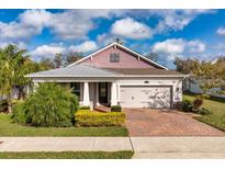 Charming single-story home with brick driveway, manicured lawn, and attached two-car garage at 2157 Bay Line Rd, Oakland, FL 34787