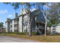 Lovely multi-story condominium featuring dual screened porches, nice landscaping and verdant surroundings at 6142 Westgate Dr # 102, Orlando, FL 32835