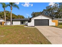 Charming single-story home with a two-car garage and a well-maintained front yard at 7427 Houston E Ct, Winter Park, FL 32792