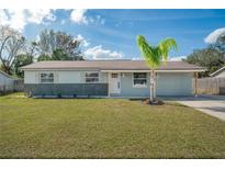 Charming single-story home featuring a well-manicured lawn and fresh exterior paint at 8042 Tompkins Sq, Orlando, FL 32807