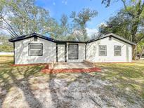 Charming single-story home with new white siding, black trim, and a welcoming brick entryway at 850 Rosalia Dr, Sanford, FL 32771