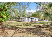Charming single story home with black trim and a large manicured front yard at 850 Rosalia Dr, Sanford, FL 32771