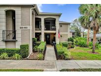 Inviting condo with walkway to front door, pretty landscaping and stacked balconies at 1055 Kensington Park Dr # 402, Altamonte Springs, FL 32714