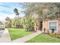 Inviting condo exterior with lush landscaping, palm trees and a well-maintained lawn at 13500 Turtle Marsh Loop # 839, Orlando, FL 32837