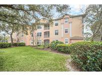 Charming condo building with lush landscaping, manicured lawn, and private screened balconies at 13500 Turtle Marsh Loop # 839, Orlando, FL 32837