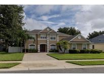 Charming two-story home with a well-manicured lawn and a paver driveway at 15313 Hayworth Dr, Winter Garden, FL 34787