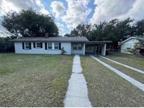 Charming single story home with a front yard and driveway at 220 Palm Ave, Auburndale, FL 33823