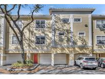 Inviting three-story townhouse featuring a private garage, neutral exterior, and well-maintained landscaping at 2425 Legacy Lake Dr # 2425, Maitland, FL 32751