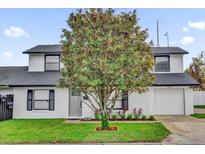 Charming two-story home featuring a well-manicured lawn and beautiful mature tree in the front yard at 2923 Cornell Ave, Orlando, FL 32804