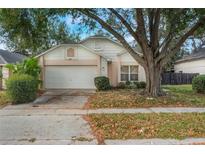 Charming single-Gathering home with a large tree, attached garage, and well-maintained landscaping at 350 Lakebreeze Cir, Lake Mary, FL 32746