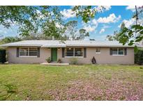 Charming single story home with mature trees and a well-manicured front lawn at 4898 Meadow Dr, St Cloud, FL 34772