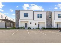 Modern townhome featuring neutral colors and a well-manicured lawn at 625 Trikomo Dr, Davenport, FL 33896