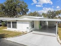 Charming single story home with a carport and well-manicured lawn, perfect for comfortable living at 7 Great Oak Dr, Fruitland Park, FL 34731