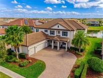 An elevated shot of this immaculate home with brick paved driveway and manicured landscaping at 7515 John Hancock Dr, Winter Garden, FL 34787