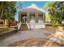 Striking two-story home with an elevated front entrance and a two car garage at 8322 Lake Lucy Dr, Orlando, FL 32818