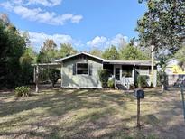 Charming single-story home with a carport and well-kept front lawn showcasing its inviting curb appeal at 1348 Cr 605, Bushnell, FL 33513