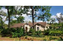 Charming single-story home with a well-manicured lawn and lush landscaping, providing great curb appeal at 398 Pine Tree Rd, Lake Mary, FL 32746