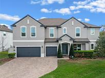 Stunning two-story home with a three-car garage, meticulously landscaped yard, and neutral paint palette at 428 White Cotton Cir, Oviedo, FL 32765