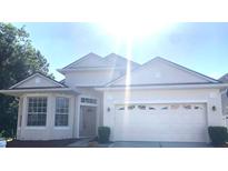 Charming one-story home with a two-car garage and manicured landscaping at 5509 Florence Harbor Dr, Orlando, FL 32829