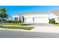 Charming single Gathering home featuring a spacious three car garage and beautifully landscaped yard at 13401 Panama Beach Ct, Orlando, FL 32827