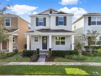 Charming two-story home with a covered front porch and nicely landscaped front yard at 15052 Mayberry Dr, Winter Garden, FL 34787