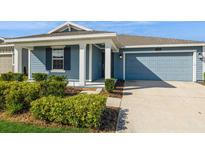 Charming blue single-Gathering home with a manicured lawn and a two-car garage in a Gathering friendly neighborhood at 1950 Birnham Wood Bnd, Kissimmee, FL 34746