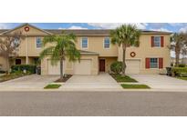 Inviting townhome featuring a 1-car garage, desert landscaping and a charming exterior design at 209 Arbor Lakes Dr, Davenport, FL 33896