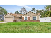 Charming home with a well-maintained lawn, appealing brick accents, and a cozy, inviting aesthetic at 1010 Corbin Ct, Oviedo, FL 32765