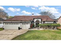 Beautiful single Gathering home with lush lawn, landscaping, and large three car garage at 1061 New Castle Ln, Oviedo, FL 32765