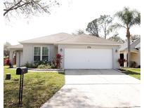 Charming single-story home featuring a two-car garage and well-maintained landscaping at 109 Grosvenor Loop, Davenport, FL 33897