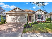 Charming single-story home with a brick driveway, attached two-car garage, and well-manicured landscaping at 123 Avenham Drive, Deland, FL 32724