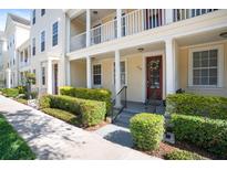 Charming townhome with a well-manicured lawn and inviting front porch, great curb appeal at 1389 Chatfield Pl, Orlando, FL 32814