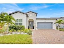 Beautiful single-story home with a well-manicured lawn, brick driveway and attached two car garage at 2117 Trani Ter, St Cloud, FL 34771