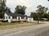 Charming house featuring a classic design, fenced yard, and welcoming front porch at 4900 Grand Ave, De Leon Springs, FL 32130