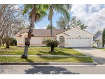 Charming single-story home featuring a well-maintained lawn, and a two-car garage, perfect for suburban living at 6385 Royal Tern St, Orlando, FL 32810