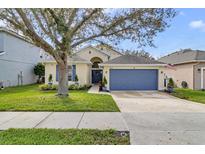 Charming single-Gathering home featuring a well-maintained lawn and inviting two-car garage at 10286 Cypress Knee Cir, Orlando, FL 32825