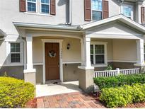 Charming front entrance with decorative wreath, porch, and well-manicured landscaping at 13730 Bravante Aly, Windermere, FL 34786