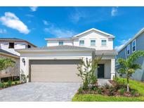 Charming two-story home with a two-car garage and manicured front yard landscaping at 3373 Lilac Way, Davenport, FL 33897