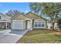 Charming single-Gathering home featuring a one-car garage, and a well-maintained front lawn at 5424 Pinto Way, Orlando, FL 32810