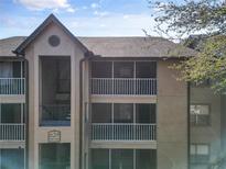 Exterior angle of the condo building, showing the staircases and screened patios at 629 Dory Ln # 303, Altamonte Springs, FL 32714