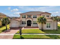 Stunning two-story home with a terracotta tile roof, lush lawn, and charming front porch at 890 Spinnaker Way, Kissimmee, FL 34746