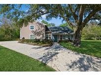 Charming two-story home featuring mature landscaping, a spacious driveway, and a welcoming front entrance at 1606 Wildcat Ct, Winter Springs, FL 32708
