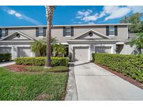 Charming two-story townhome with attached garage, landscaped yard, and well-maintained exterior at 2080 Switch Grass Cir, Ocoee, FL 34761