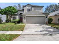 Charming two-story home with a well-maintained lawn and an attached two-car garage at 4273 Northern Dancer Way, Orlando, FL 32826