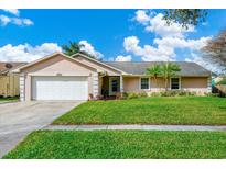 Charming single-story home featuring a well-manicured lawn and a two-car garage, under a sunny, partly cloudy sky at 4722 Sturbridge Cir, Orlando, FL 32812