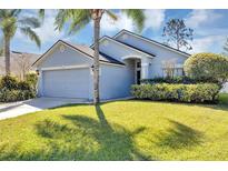 Charming single-story home features a well-manicured lawn and an attached two-car garage at 515 Mickleton Loop, Ocoee, FL 34761