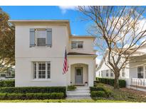 Charming two-story home with blue shutters and an inviting covered entry and a well manicured front lawn at 5238 Baskin St, Orlando, FL 32814