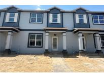Charming townhome showcasing a modern, two-story facade with stylish accents at 15352 Burgtheater Dr, Winter Garden, FL 34787